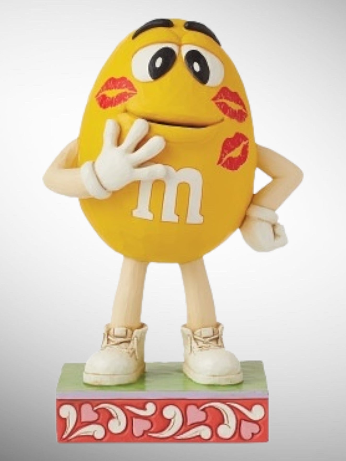 Jim Shore M&M's Collection - Is There Something On My Face? Yellow Kisses Figurine - PREORDER